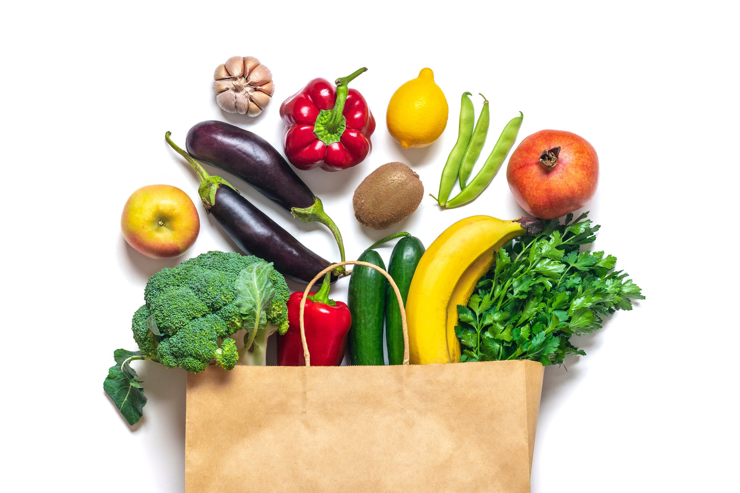 Paper bag filled with assorted fruits and vegetables including broccoli, banana, eggplant, and peppers