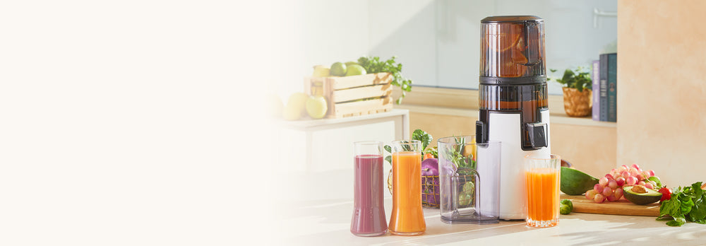 Juicer on a kitchen counter with fruits and drinks around H70ST