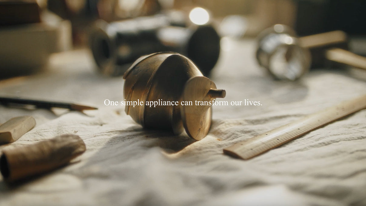 A close-up shot of a Hurom juicer screw on a craftsman's workbench, surrounded by measuring tools and pencils. Overlay text reads, "This is the story of a simple appliance transforming everyday routines," reflecting the brand's goal of improving daily life through thoughtful design.